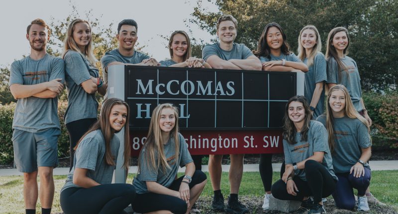 Group photo at McComas Gym sign